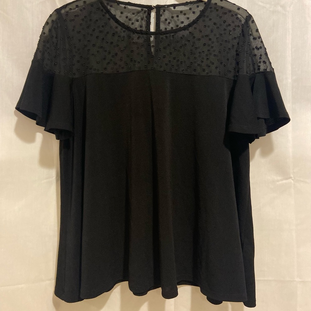Black top with a mesh polkadot top portion